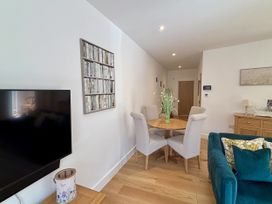 A living room with a dining table and chairs at 8 Church Road in Ferndown