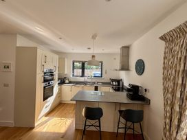 A kitchen with a dining area and appliances at 8 Church Road Ferndown