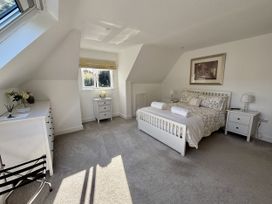 A bedroom with a bed and side tables at 8 Church Road in Ferndown