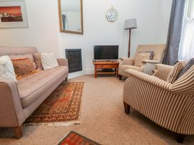 A living room with a sofa and television at Pelican Cottage in St Ives