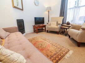 A living room with a sofa and armchairs at Pelican Cottage in St Ives