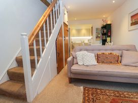 A living room with a staircase and a sofa at Pelican Cottage in St Ives