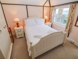 A bedroom with a bed and a window at Pelican Cottage in St Ives