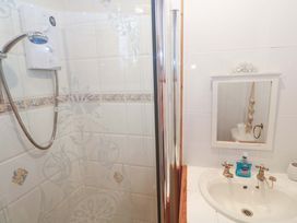 A bathroom with a shower and sink at Pelican Cottage St Ives