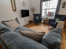 A living room with a sofa and armchairs at Pelican Cottage in St Ives