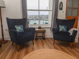 A living room with two armchairs and a side table at Pelican Cottage St Ives