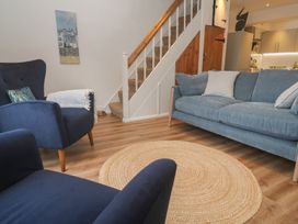 A living room with a sofa and chairs at Pelican Cottage St Ives