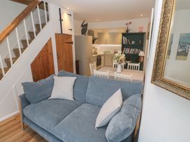 A living room with a couch and dining table at Pelican Cottage in St Ives