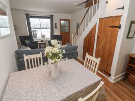 A living room with a dining table and sofa at Pelican Cottage in St Ives