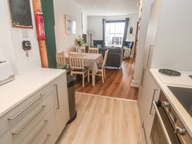 A kitchen area leading to a dining area at Pelican Cottage St Ives