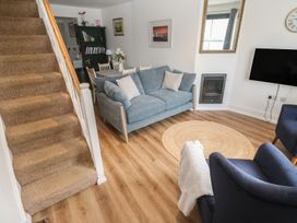 A living room with a sofa and armchairs at Pelican Cottage in St Ives