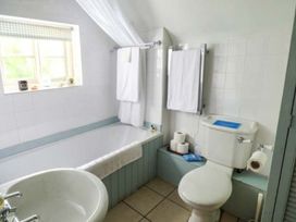 A bathroom with a bathtub, toilet, and sink at The Smithy in Lucton near Mortimers Cross