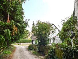 A view of a road with trees and a house at The Smithy in Lucton near Mortimers Cross