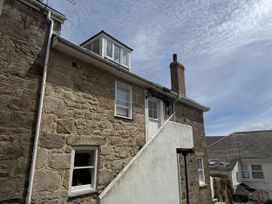 A building with stone walls and windows at Crows Nest in St Ives