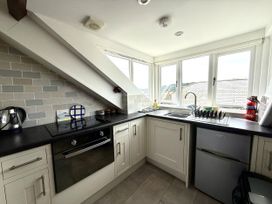 A kitchen with a sink and stove at Crows Nest in St Ives