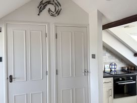 A kitchen with doors and a stove at Crows Nest in St Ives