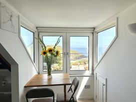 A dining area with a table and chairs at Crows Nest in St Ives