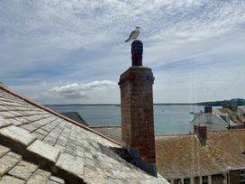 A view of a chimney and a seagull with the ocean in the background at Crows Nest in St Ives