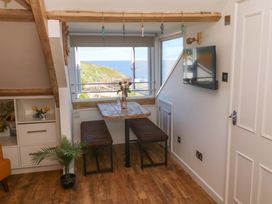 A dining area with a table and chairs at Seagulls Nest in St Ives