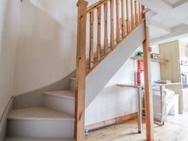 A staircase and kitchenette area at The Hayloft in Bodelwyddan