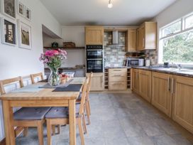 A kitchen with a dining table and chairs at The Hayloft in Bodelwyddan