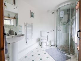 A bathroom with a shower, sink, and toilet at The Hayloft in Bodelwyddan