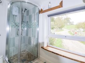 A shower with glass enclosure in a bathroom at The Hayloft in Bodelwyddan