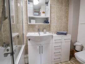 A bathroom with a sink, bathtub, and shower at The Hayloft in Bodelwyddan