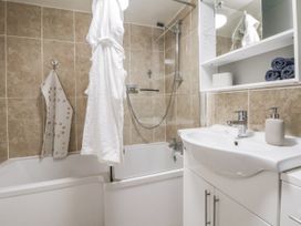 A bathroom with a bathtub and sink at The Hayloft in Bodelwyddan