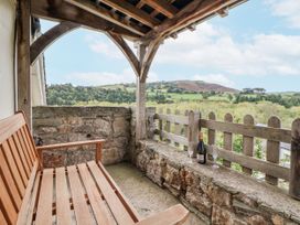 A outdoor seating area with a bench and drinks at The Hayloft in Bodelwyddan