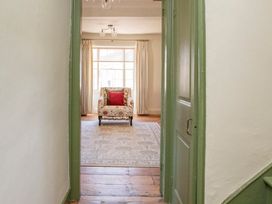A living room with a chair and window at Apartment 2, 86 Dyer Street Cirencester
