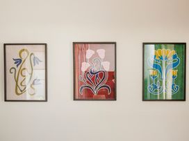 Three framed artworks on a wall at Apartment 2, 86 Dyer Street Cirencester