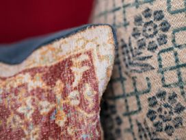 Close-up of decorative cushions with different patterns in Apartment 2, 86 Dyer Street Cirencester