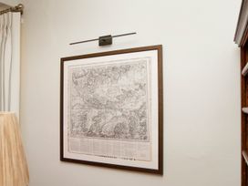 A wall with a framed map and light fixture at Apartment 2, 86 Dyer Street Cirencester