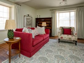 A living room with a sofa and armchair at Apartment 2, 86 Dyer Street in Cirencester