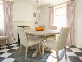 A dining room with a round table and chairs at Apartment 2, 86 Dyer Street Cirencester