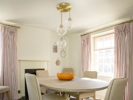 A dining room with a round table and chairs at Apartment 2, 86 Dyer Street Cirencester