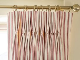 A curtain with vertical stripes in a living room at Apartment 2, 86 Dyer Street in Cirencester