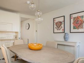A dining room with a table and chairs at Apartment 2, 86 Dyer Street Cirencester