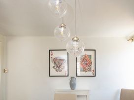 A dining room with wall art and light fixtures at Apartment 2, 86 Dyer Street Cirencester