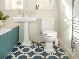 A bathroom with sink, toilet and towel rail at Apartment 2, 86 Dyer Street Cirencester