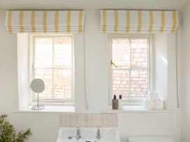 A bathroom with sinks and windows at Apartment 2, 86 Dyer Street Cirencester