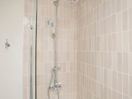 A shower with tiles and fixtures at Apartment 2, 86 Dyer Street Cirencester