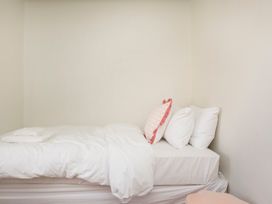 A bedroom with a bed and pillows at Apartment 2, 86 Dyer Street Cirencester