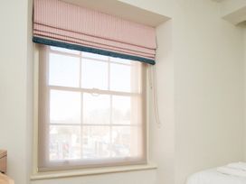 A window with curtains in a bedroom at Apartment 2, 86 Dyer Street Cirencester