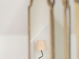 A lamp in front of mirrors at Apartment 2, 86 Dyer Street, Cirencester