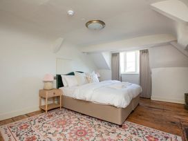 A bedroom with a bed and nightstand at Apartment 2, 86 Dyer Street Cirencester
