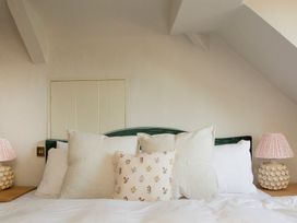 A bedroom with pillows on a bed at Apartment 2, 86 Dyer Street Cirencester