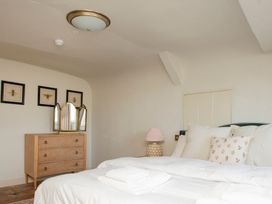 A bedroom with a bed and chest of drawers at Apartment 2, 86 Dyer Street Cirencester