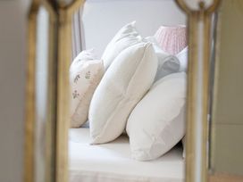 A bed with pillows and a lamp at Apartment 2, 86 Dyer Street, Cirencester